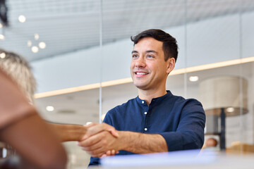 Business handshake of partners, young male bank manager and female client or hr and employee at...