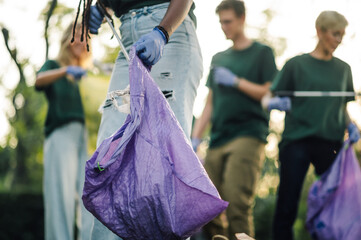Group of people volunteering picking up trash in park