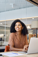 Happy young African American business woman employee using laptop at work in office. Professional...