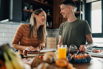 Lesbian couple preparing breakfast and having fun in the kitchen