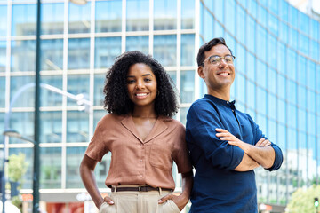Young happy smiling professional office team of two diverse confident female and male partners...