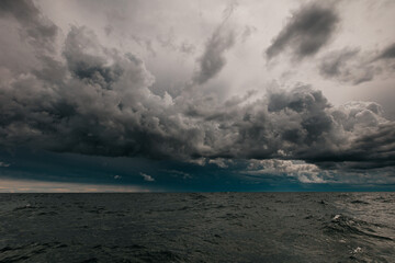 The dark sky with heavy clouds converging and a violent storm before the rain.Bad or moody weather...
