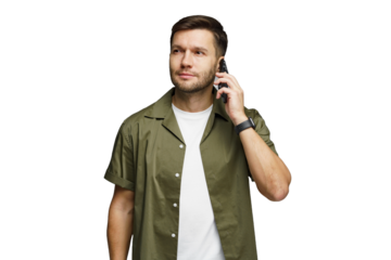 Man in green shirt talking on a phone, looking thoughtful in a bright, simple setting