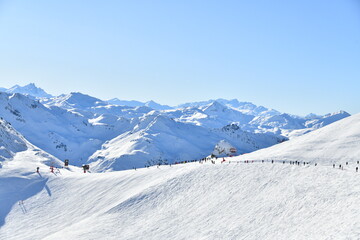 Obraz premium Skiers on the slopes of Courchevel ski resort,French alps.
