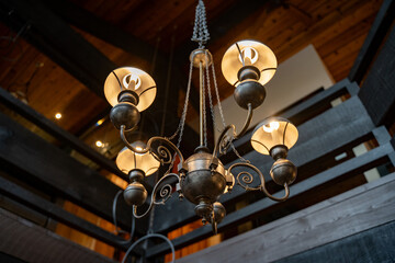 Elegant chandelier in a wooden house