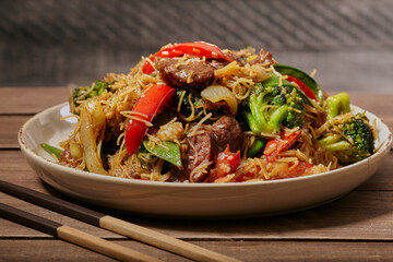 Beef and vegetable stir fry with rice noodles.