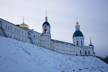 Large building with two domes and a clock tower