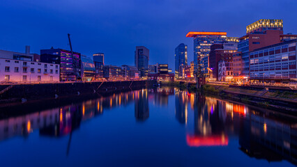 Fototapeta premium Dusseldorf, Germany. Cityscape image of Düsseldorf with the Media Harbour and reflection in the Rhine river, at the evening