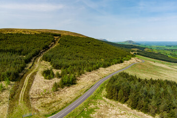 Aerial view of endless lush pastures and farmlands of Ireland. Beautiful Irish countryside with emerald green fields and meadows.