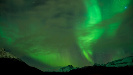 Aurora Borealis over Lyngen mountains in late autumn in northern Norway