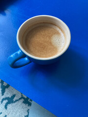 Blue coffee cup on a blue table