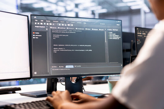 Developer in data center workspace using diagnostic tools and system monitoring software to identify root cause of errors. Woman working in server farm, mending equipment