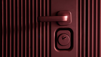 Stylish dark red door handle, mortise lock and keyhole on a modern entrance metal armored designer door. Privacy and protection of the apartment and house. Photo