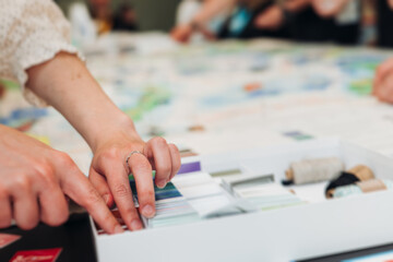 Process of playing tabletop board game on the table, fun with friends and family in room indoors, board game party concept, company group of students adults play board games, roll the dice on game map