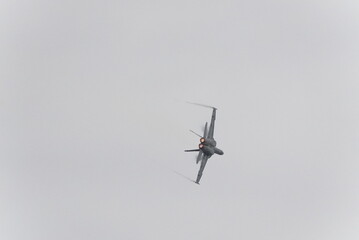 F16 fighter jet doing stunts and tricks at an airshow