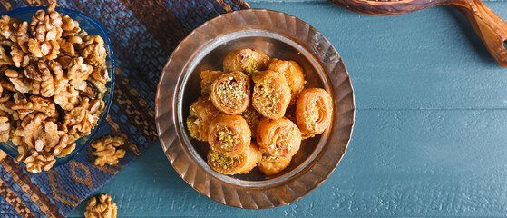 Composition with delicious baklava on color wooden background
