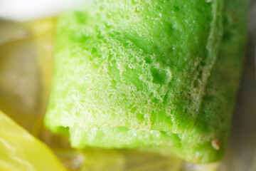 Coconut grated Pandan crepe know as Kuih Dadar. It is combination of sweet filling made from grated coconut and gula Melaka, wrapped in delicate, soft green crepes