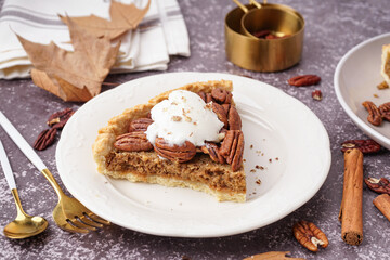 Plate with piece of tasty pecan pie on grey background