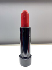 red lipstick on a gray wall background, very popular with women