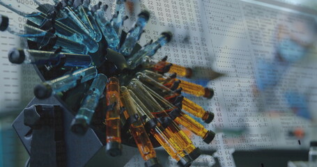 Image of data processing over test tubes in laboratory