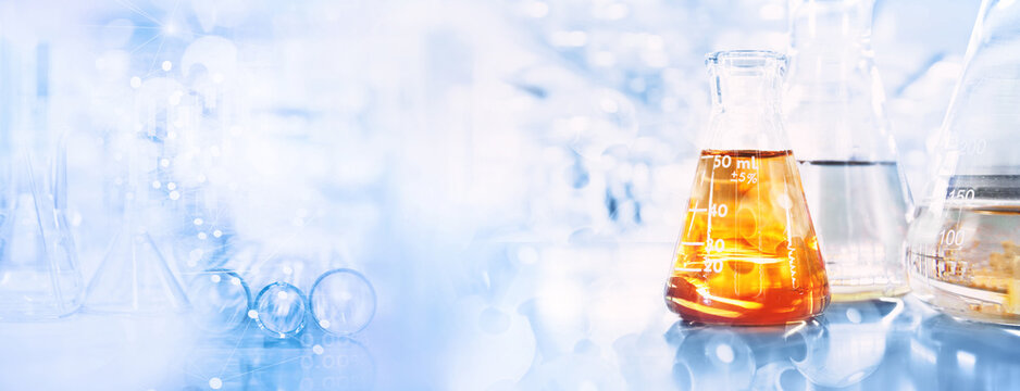 orange solution in flask and test tube in science research lab with blue banner background