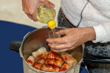 Woman's  hands cooking traditional dish and adding seasoning. A preparing a delicious meal. Meal time