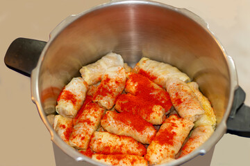 A cooking traditional dish and adding seasoning. A preparing a delicious meal. Meal time
