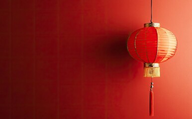 Fototapeta premium Red Chinese Lantern Hanging Against Red Wall