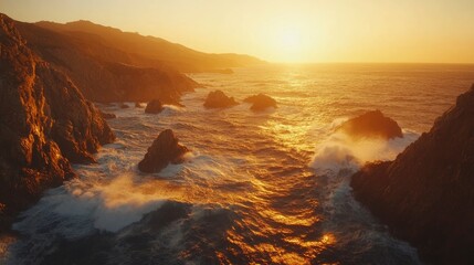 Serene sunset over rocky coastline with crashing waves and distant mountains in soft golden light