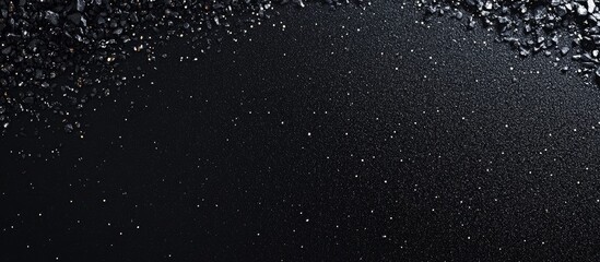 Obraz premium Black water surface with scattered droplets and bubbles creating a textured background with copy space for text placement.