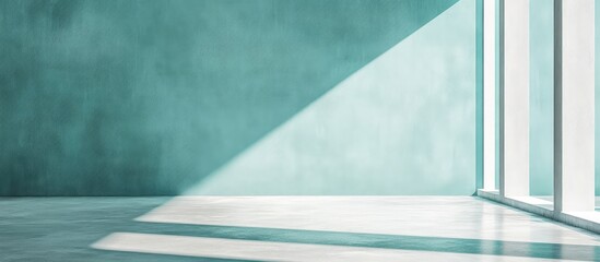 Long panoramic view of mint turquoise cement concrete wall texture with soft gradient effect and bright sunlight casting shadows, ideal for background use
