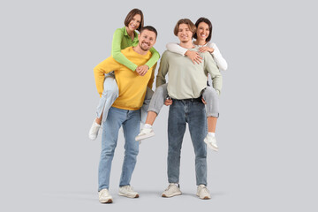 Obraz premium Group of young people in jeans on light background