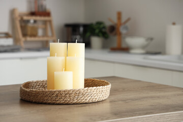 Romantic candles on kitchen table in room. Closeup