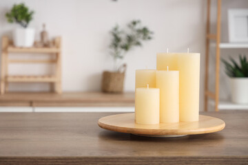 Candles on wooden table in modern kitchen