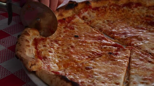 Child battling to cut a slice of pizza. Slow motion x0,5