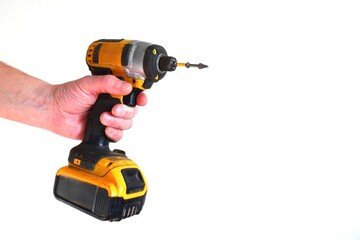 Cordless drill in hand on a white background close-up