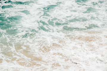 Beach Sand Sea Shore with Blue wave and white foamy Summer background
