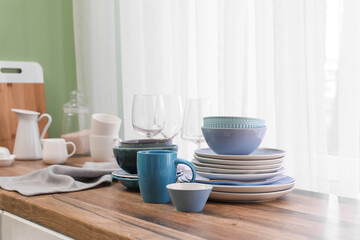 Clean blue dishes on counter near window in kitchen