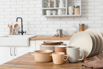 Clean dishes on wooden table in kitchen
