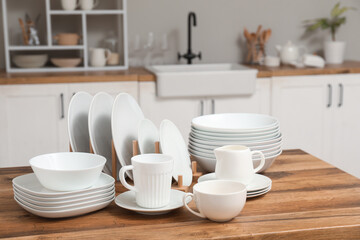 Clean white dishes on counter in kitchen
