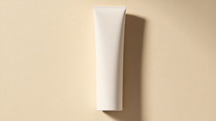 Blank white cosmetic tube on beige background