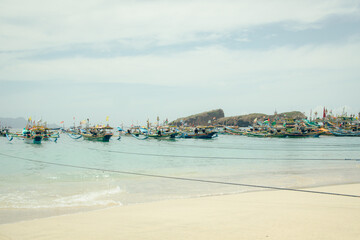 Blitar, Indonesia - January 14, 2024: View of Tanjung Papuma beach in Jember, Indonesia. Beach with beautiful boats