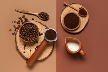 Portafilter with coffee powder, jug of milk and beans on color background