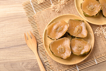Sticky rice cake (Nian Gao), Chinese New Year cake on wooden plate, Table top view