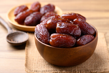 Date palm fruit (MedJool) in wooden bowl