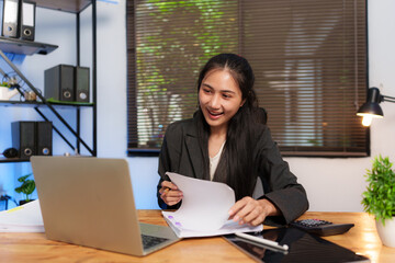 Asian business woman happily working at office
