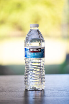 Closeup of a closed Kirkland water bottle from costco on the table