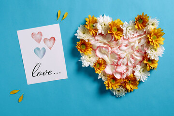 Colorful flower heart and love card creating a romantic valentine's day scene on a vibrant blue background