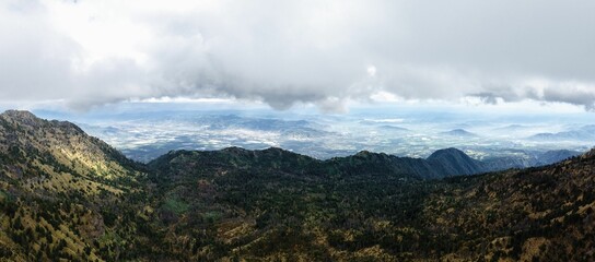 Panoramic mountain landscape under clouds.