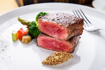 Deliciously grilled beef steak with vegetable garnish
